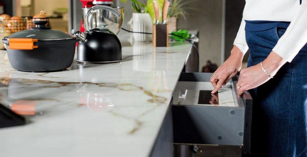 Best induction burner for compact kitchens — single invisible hob in use with stainless steel saucepan