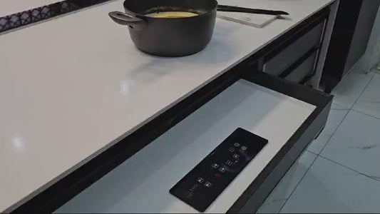 Hidden induction hob single burner installed beneath granite countertop — invisible cooking surface from below